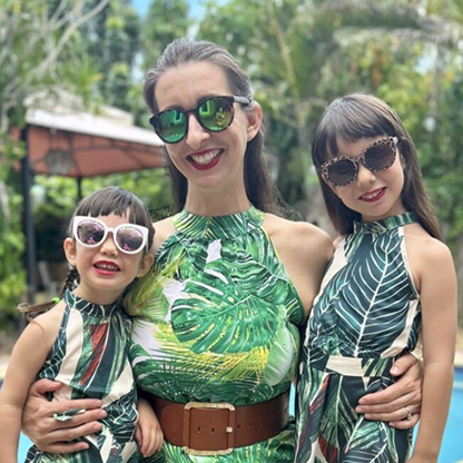 Emilie with 2 daughters in green dresses and sunglasses
