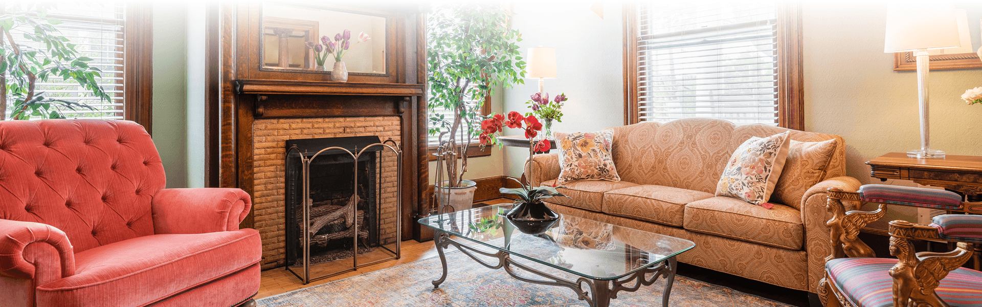 Two couches placed next to a historic fireplace